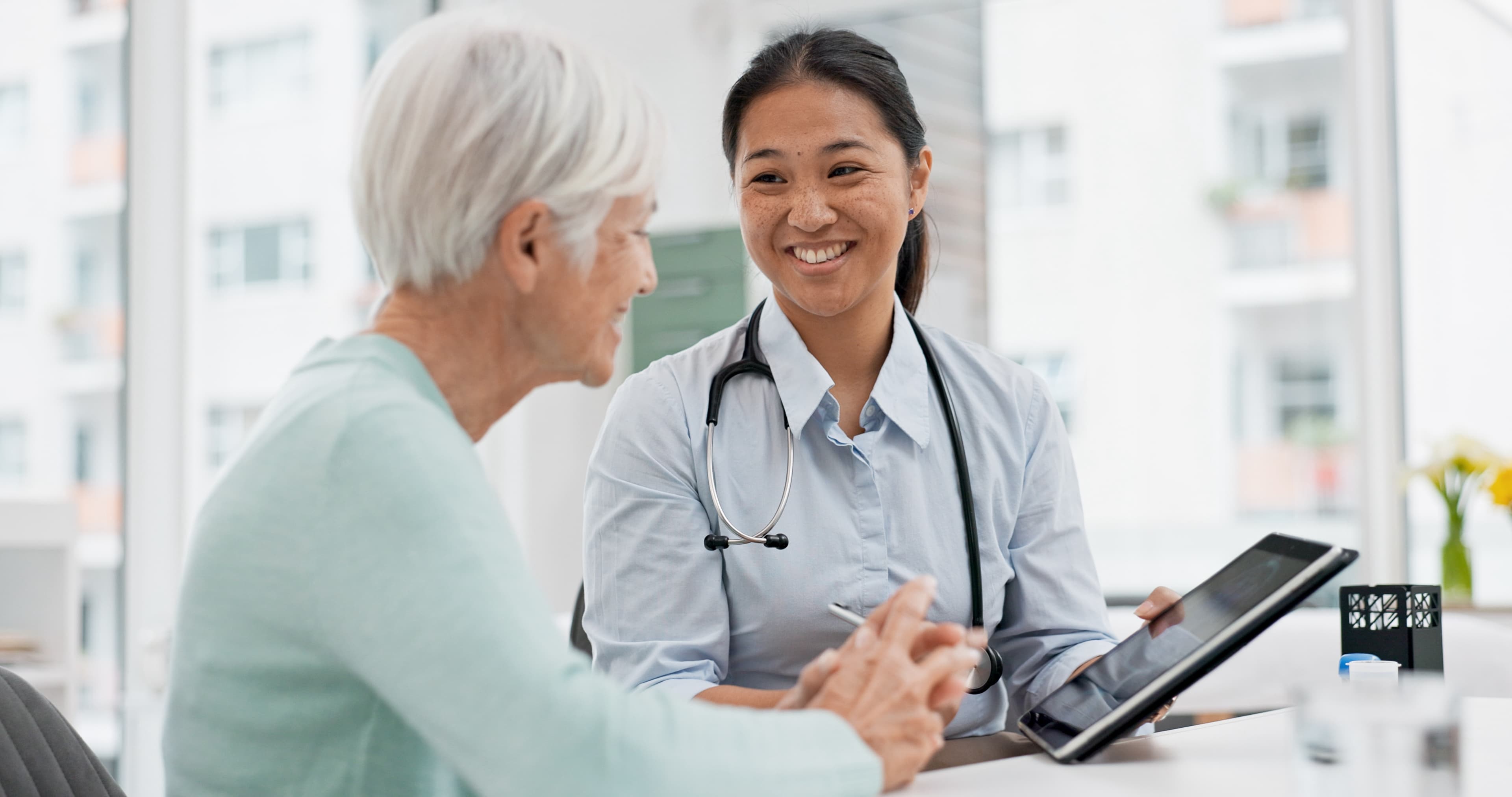 female doctor smiling at older woman