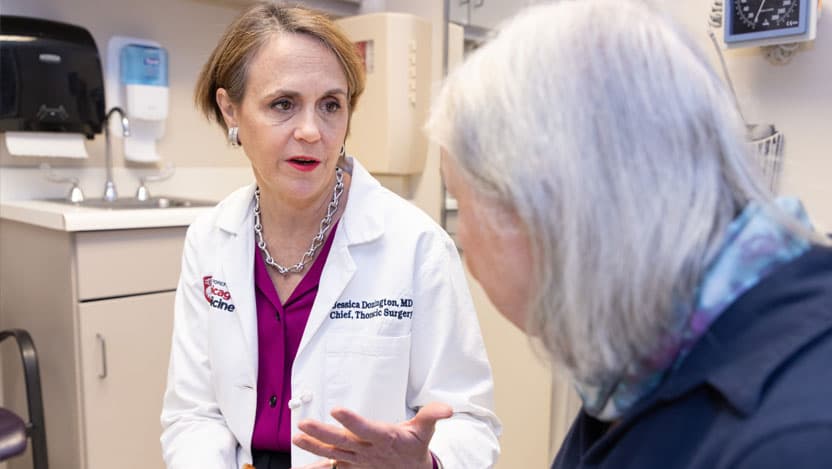 Thoracic surgeon Jessica Donington, MD, meets with a patient in clinic