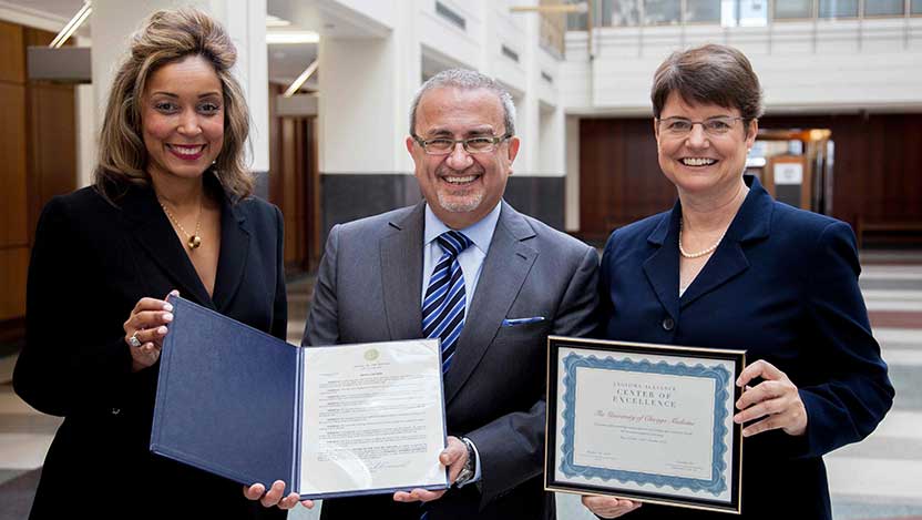 Dr. Awad holding the Mayoral Proclamation