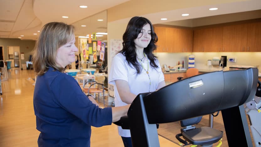 Female patient on a treadmill during physical therapy