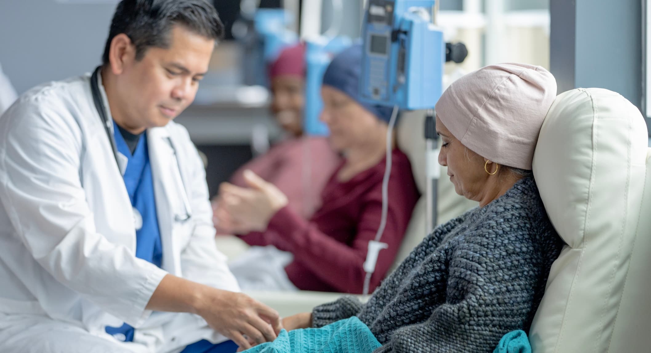 Woman receiving chemotherapy infusion from physician