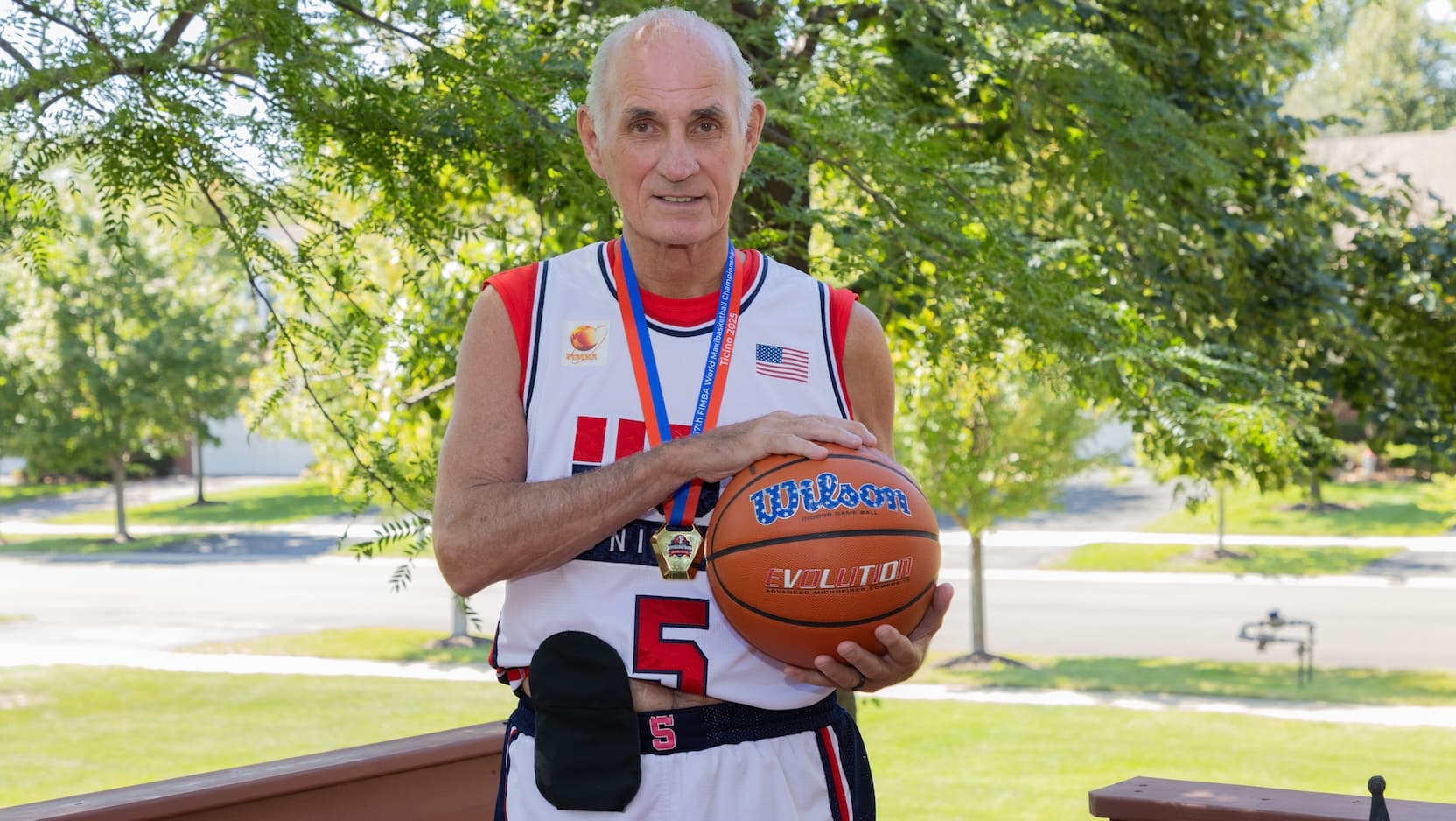 Mel Mocco with basketball and ostomy bag