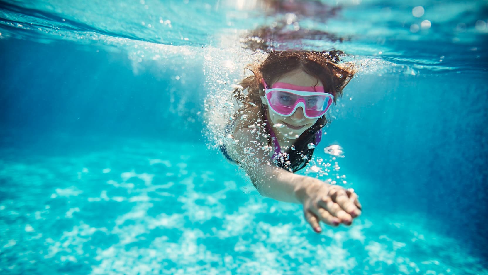 Teen swimming underwater