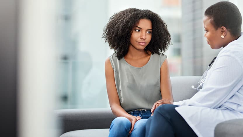 Patient having serious talk with gynecologist