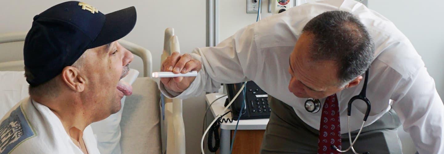 Dr. Bishop examining Scott McIntyre's throat