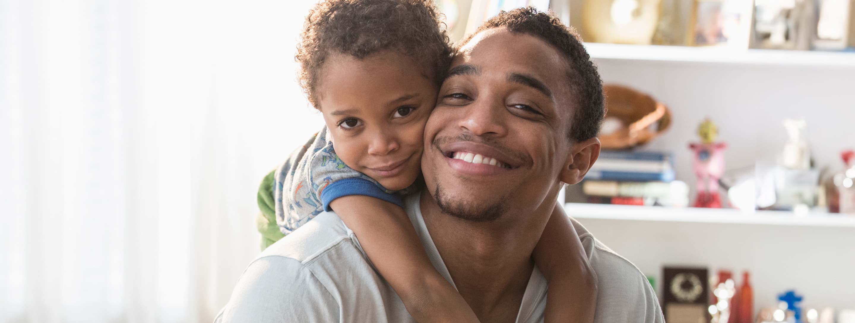 Father with son embracing him, at home