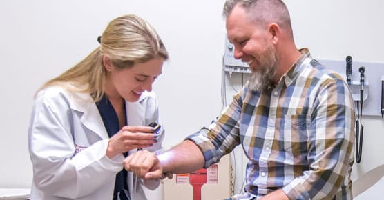 Dermatologist Ashley Feneran, DO, with patient in South Loop