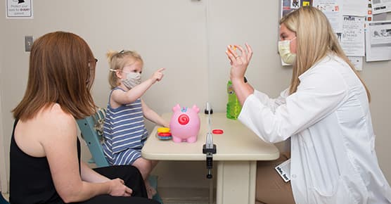 Image of speech language pathologist Caitlin Egan working with pediatric patient