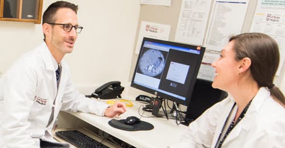 Andrew Arohnson, MD, and colleague in clinic