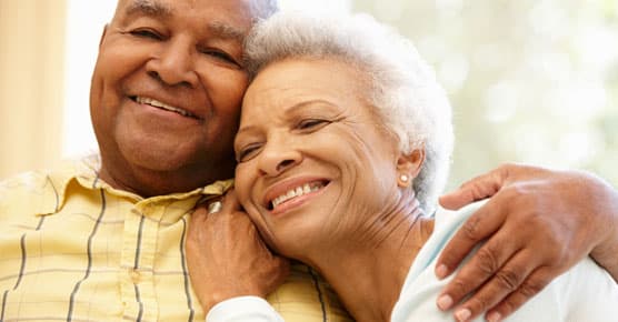 African-American elderly couple embracing