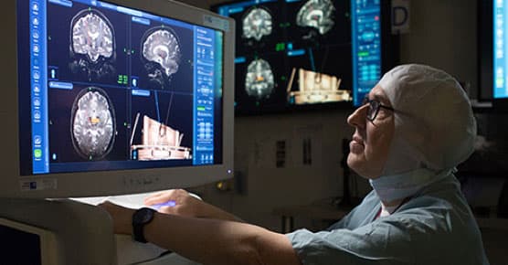 Peter Warnke, MD, in surgery with scans