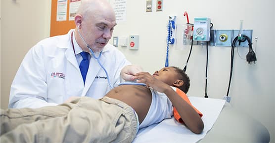 Image of Dr. Cunningham working with pediatric cancer patient