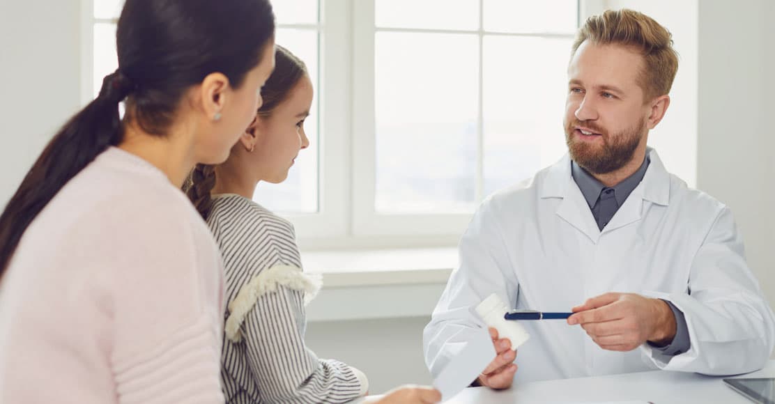 Male physician meeting with mother and daughter