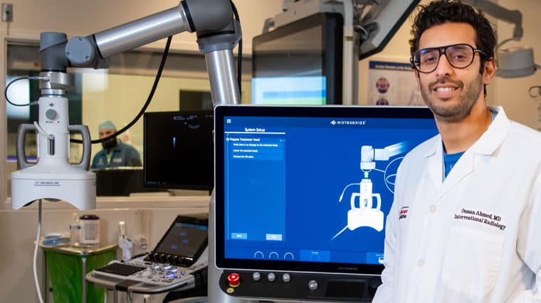 interventional radiologist Osman Ahmed, MD, with histotripsy machine