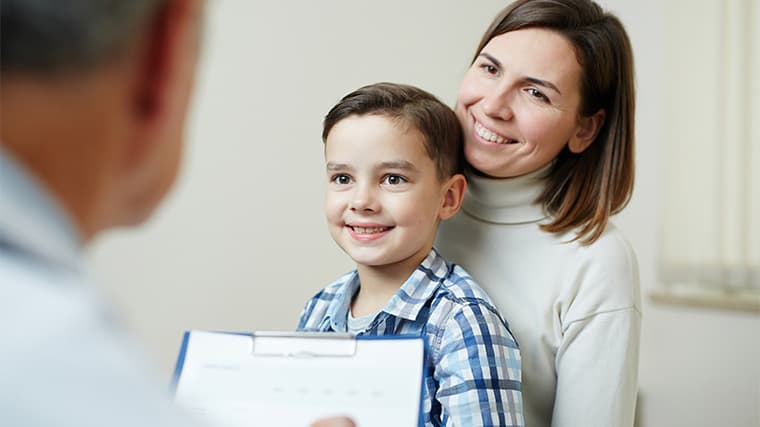 woman and son looking at doctor and listening to his recommendations