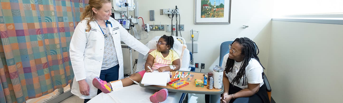 Patient Assata McPherson and her mother Jennifer Fikes get a visit from Dr. Wendy Darlington while receiving pediatric anemia treatment.