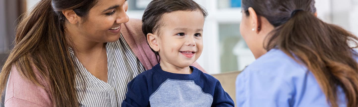 Pediatric patient and parent talking to doctor about pediatric food allergies