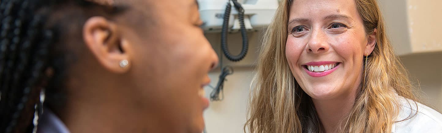 Gynecologist Carrie Smith, MD, talking with a patient